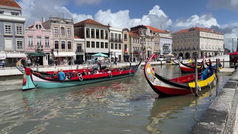 Aveiro , Portugal - 04 12 2022: Tourists on a moliceiro boat sail along the central canal of Ria de Aveiro