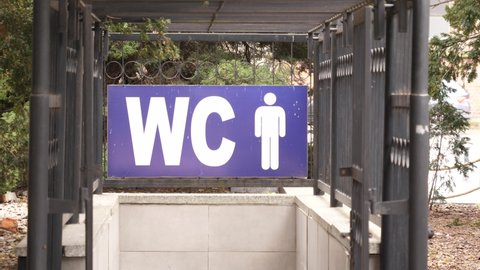 WC toilet sign over an entrance to toilet on a street of Wroclaw Poland
