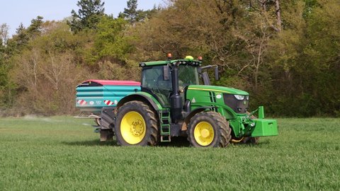 Perry Green, Much Hadham, Hertfordshire. UK. April 22nd 2022 Tractor with a fertiliser spreader working in a field in spring.