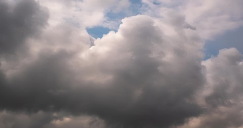 Timelapse of sky background with tiny striped clouds before storm with dark clouds