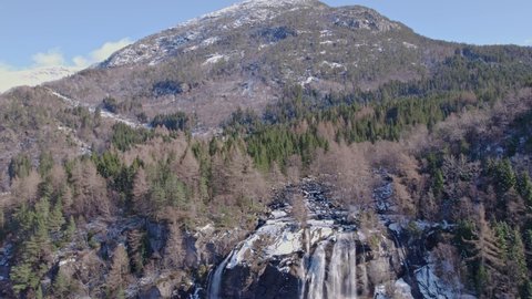 drone shot The Furebergfossen waterfall and bridge above Hardanger fjord spring snow near Odda Norway