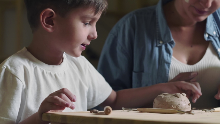 Mother and son plays with clay at home