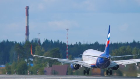 MOSCOW, RUSSIAN FEDERATION - SEPTEMBER 12, 2020: Boeing 737 of Aeroflot touches the runway and braking at Sheremetyevo airport, Moscow. Airplane arriving at the airport on a summer sunny day