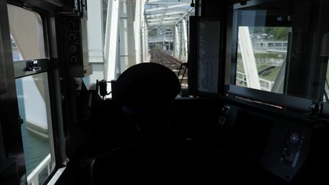 Kyoto, Japan: April 23, 22: Inside front view of a train with a driver in Japan. Driving a tram or a train in Hiroshima. High quality 4k footage.