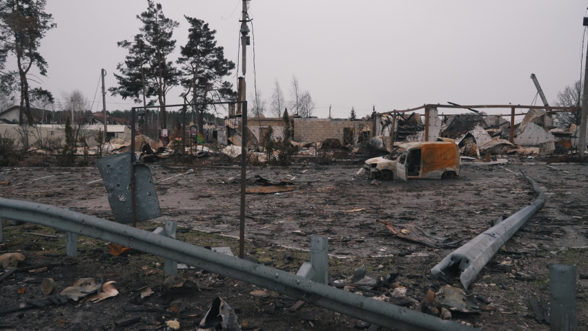 destroyed houses and a car of civilians in the war
