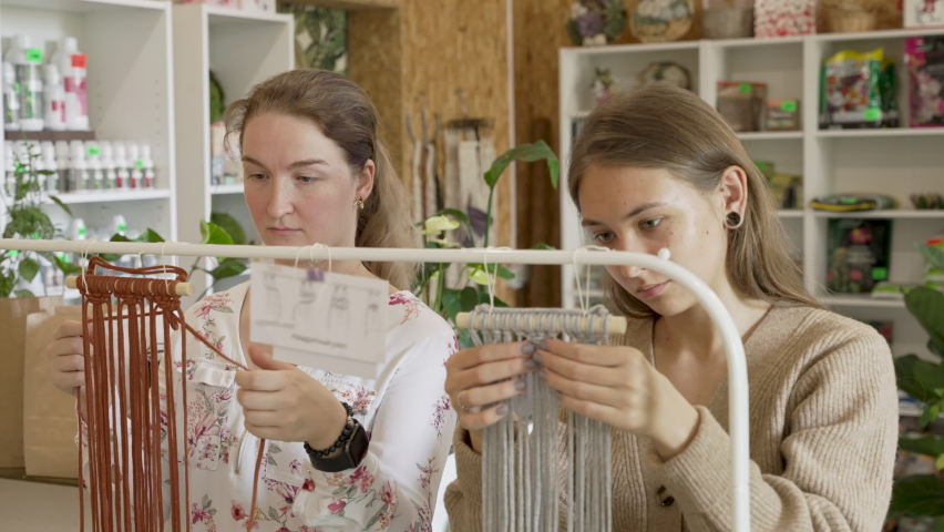 Group of women attending art class. Female students and teacher makes home decor in Boho style in workshop together. Weaves handmade macrame at art school studio. Creativity, people education | Shutterstock HD Video #1089549605