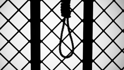 Gallows shadow close-up. Silhouette of rope with noose for suicide. Horror film concept. 