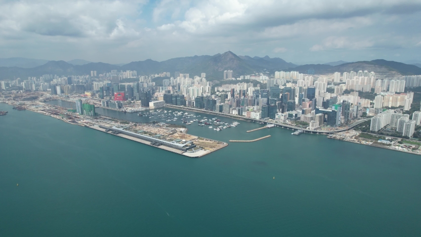 Sport theme commercial residential facility construction site in Kai Tak Hong Kong city, Kwun Tong and Kowloon Bay near Victoria harbor, Aerial drone | Shutterstock HD Video #1089554163