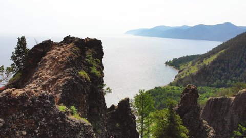 View from the Skriper cliff to Lake Baikal on a sunny summer day. Aerial view.