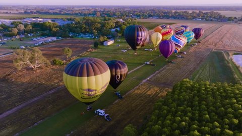 Milawa, VIC, Australia - 26-Mar-2022 - Hot Air Balloons taking off at the King Valley Balloon Fiesta at sunrise. 