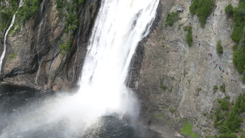 Panning up of a waterfall. Location : Momenrency Fall, Quebec, Canada