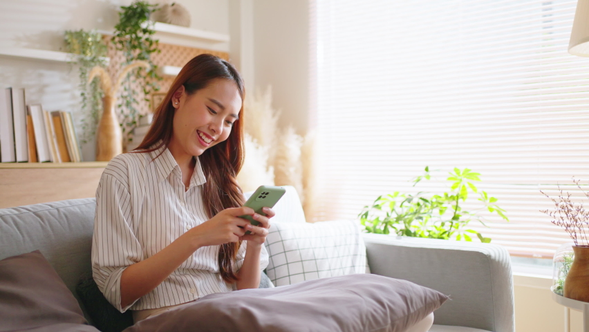 Asian woman using credit card.Happy cheerful girl enjoying online shopping,using ecommerce app on smartphone,paying for purchase, order by credit card,buying goods on Internet.online shopping concept. Royalty-Free Stock Footage #1089564841