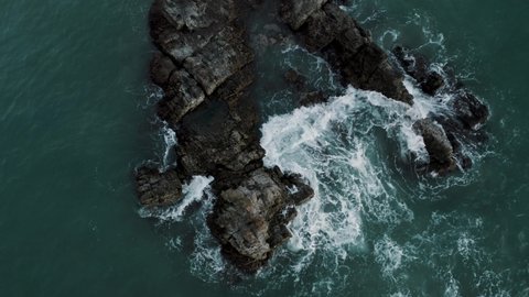 Puerto Escondido Beach With Breaking Waves Onto Outcrops And Surfers In Oaxaca, Mexico. Aerial Ascending