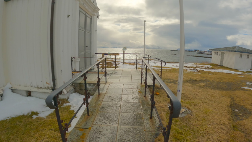 Revealing the scenery view in front of Dverberg Church on Andoya in Norway, Vesteralen. Forwarding shot.
