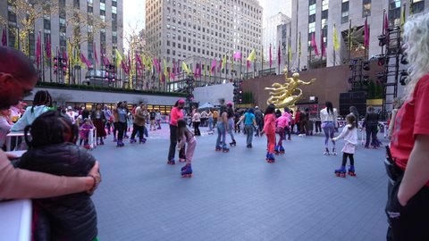 New York , New York , United States - 04 13 2022: Rockefeller Centre Flipper’s roller skating rink, New York City, wide