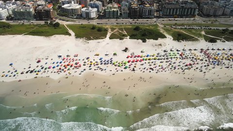 spring break, people on a beautiful white sand beach in Rio de Janeiro, Brazil. Aerial view