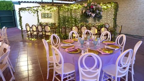 Coziness and style. Modern event design. Table setting at wedding reception. Floral compositions with beautiful flowers