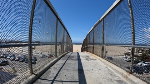 View crossing Pacific Coast Highway on a Santa Monica beach pedestrian bridge in Los Angeles County, California.