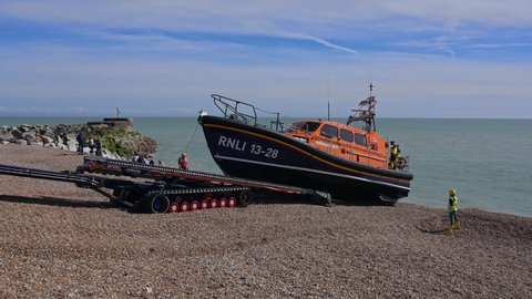 Hastings, East Sussex, UK, April 13, 2022. The RNLI Shannon Class Lifeboat being winched onto the launch and recovery system at Hastings.
