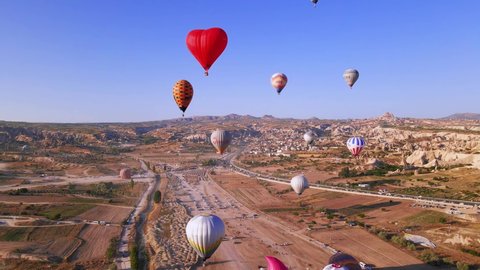 Cappadocia, Turkey – April 1, 2022: Aerial view of hot air balloons flying at sunrise, 4k