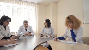 Team of caucasian doctors having a meeting in conference room. Healthcare and science concept. Meeting in a modern hospital building - Powered by Shutterstock - Get 15% off with code: PIKWIZARD15