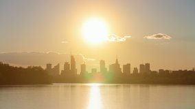 Day to night transition in big city skyline time-lapse shot Warsaw Poland, high skyscrapers illumination reflected on Wisla river surface. Downtown cityscape panorama lit with warm sunset light - Powered by Shutterstock - Get 15% off with code: PIKWIZARD15