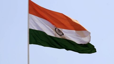 India flag flying high with pride in blue sky, India flag fluttering, Indian Flag on Independence Day and Republic Day of India, tilt up shot, waving Indian flag, Flying India flags