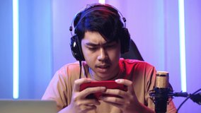 Asian Man Playing Video Game With Mobile Phone Then Lose The Game While Live Stream 
