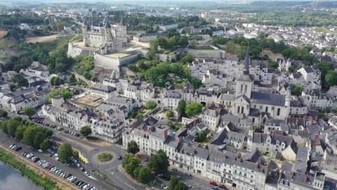 Scenic aerial view of Saumur town on banks of Loire in western France overlooking ancient castle and parish church in summer