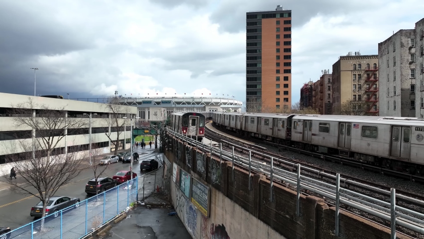 NYC, USA - APRIL 14, 2022: two subway trains crossing paths outside Yankee Stadium in the South Bronx, New York City.