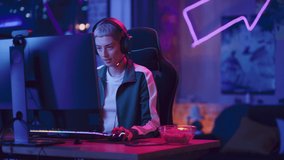 Excited Female Gamer Playing Online Video Game on Computer. Portrait of Slightly Stressed Woman in Headphones Battling in PvP Tournament with Other Players, Talking with Team on Microphone.