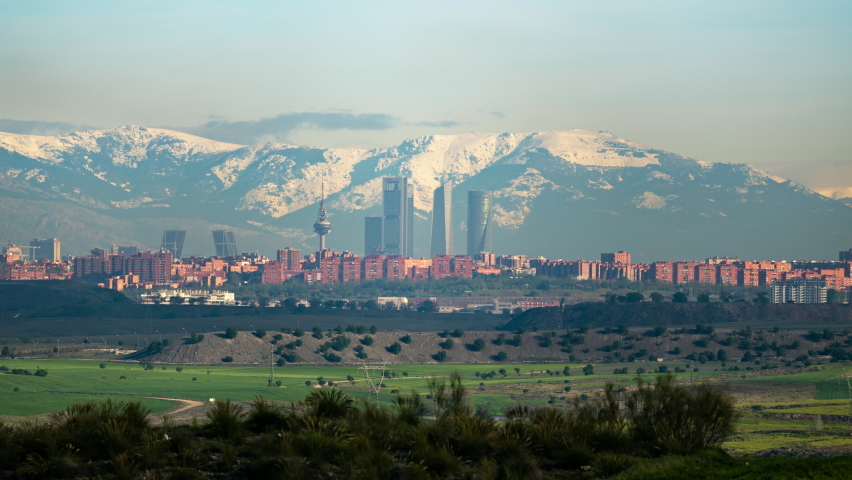 Timelapse of Madrid Skyline and the Sierra covered in Snow