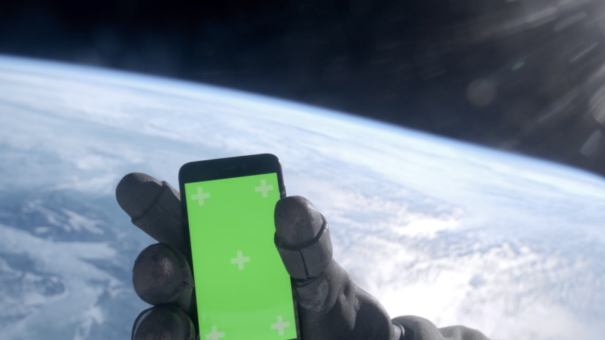 POV First person view through the astronaut helmet, astronaut using his mobile phone during the spacewalk. Green screen chroma key. Earth in the background Royalty-Free Stock Footage #1089584709