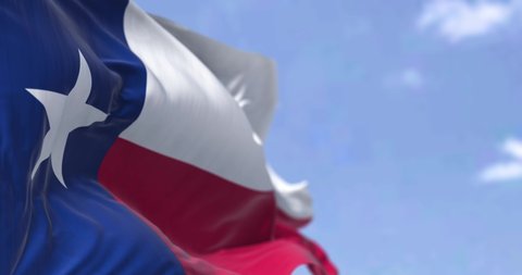 The US state flag of Texas waving in the wind. Texas is a state in the South Central region of the United States. Democracy and independence. Seamless loop in slow motion. 4K resolution