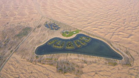 Aerial view of man-made Dubai lake in the middle of the desert in the shape of the United Arab Emirates with Dubai shaped with trees and greenery - Dubai, UAE - Nov'19
