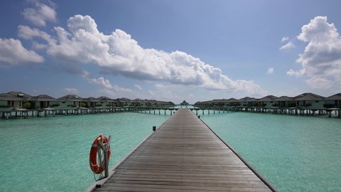 Maldives paradise island. Luxury overwater villas on blue lagoon, white sandy beach 