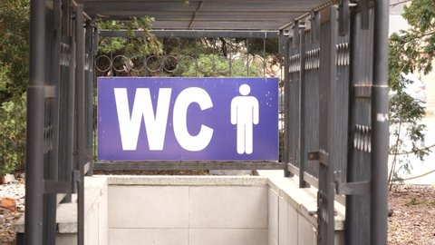 WC toilet sign over an entrance to male lavatory on a street of Wroclaw Poland