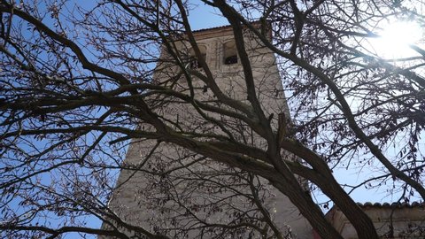 Tower seen between the trees of Arevalo. Castile La Mancha Church. Arevalo. Spain.