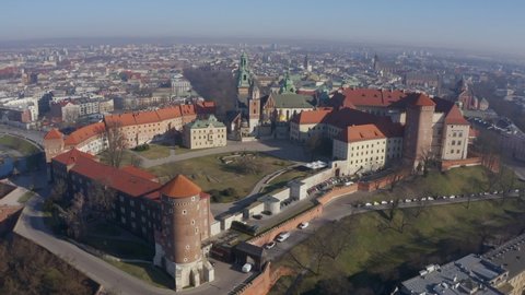 Wawel castle on the hill in Krakow Poland. Aerial video footage. Drone view from above. Morning sunlight beautiful atmospheric fog over the old historic city