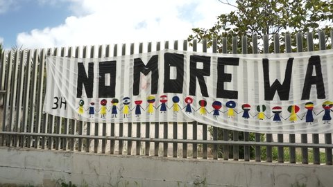 Rome, Italy - April 25, 2022, anti-war banner, designed by kids and shown outside a school.