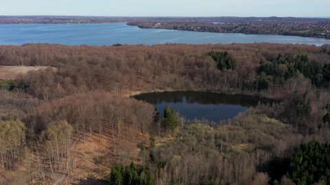 Bagsvaerd, Denmark - April 20, 2022: Aerial drone view of Store Hulsoe Lake with Furesoe Lake in the background.