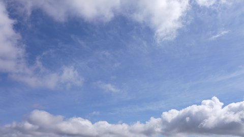 Beautiful morning sunny clear blue sky with small fluffy white clouds flying overhead in clear blue sky background. 4k video time lapse of cloudy sunny peaceful blue sky. Natural abstract background