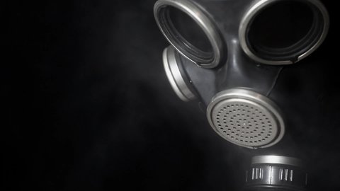 footage of gas mask smoke dark background