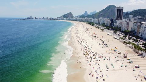 Fly over Copacabana beach, a famous sandy beach in Rio de Janeiro, Brazil