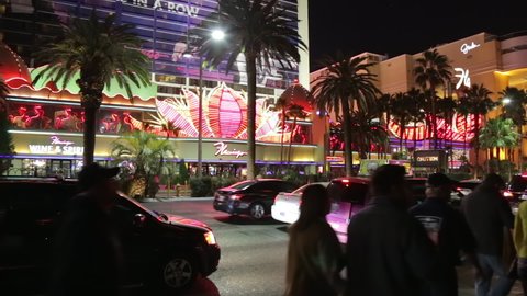 Las Vegas, USA - January 2016 : Flamingo Las Vegas hotel and casino exterior with people walking and cars on the Strip at night