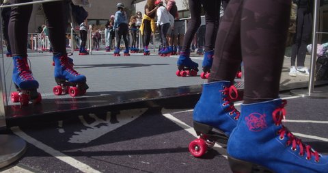 New York, New York United States - April 23,  2022: Flipper's Roller Boogie Palace at The Rink in Rockefeller Center. Close up of skates as people exit the rink.