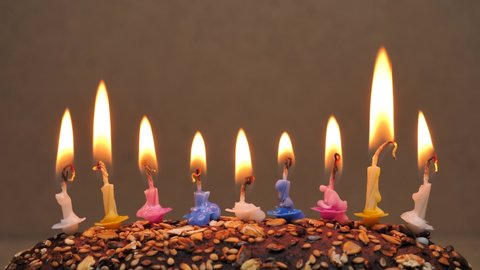 Burning candles in a birthday cake. Close up colorful flame candles in homemade cake.Birthday candles for home party