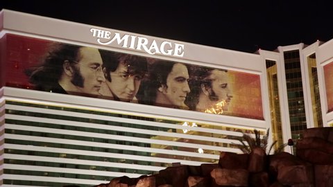 Las Vegas, USA - January 2016 : Facade of The Mirage hotel at night with the faces of the four members of The Beatles displayed from the Cirque du Soleil show Love, in Nevada, USA