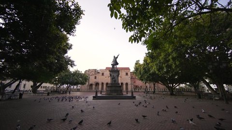 Dominican Republic, Santo Domingo - January 28, 2022: Motion forward to monument to Christopher Columbus on the main square of Columbus Park without people early morning. Colonial city