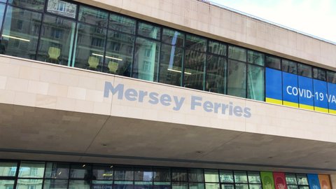 Liverpool, UK, April 16th 2022: The Mersey Ferries sign, ferry port at the Pier Head waterfront. Public commuter travel service across the River Mersey from Liverpool City Centre to Woodside terminal,